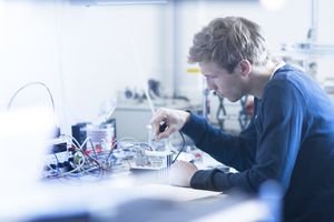 Technician constructing electric component part