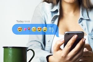 Woman texting with emojis