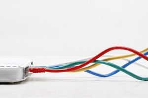 Colored cables going in to a networking router.
