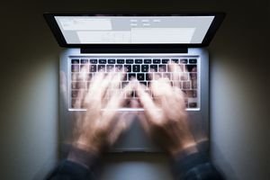 Hands typing on computer