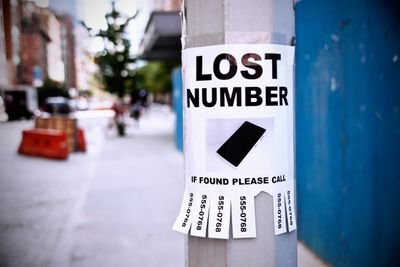 Photo of a LOST NUMBER sign on a street pole