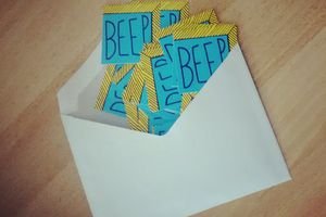 High Angle View Of Beep Text On Paper In Envelope