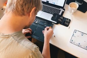 man repairing computer