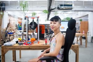 Person in 3D printing workspace