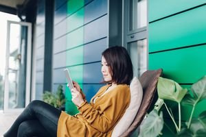 Young lady reading news on tablet