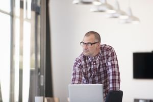 Businessman using laptop in modern office