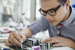 Focused engineer assembling circuit board