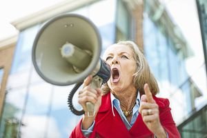 Older woman shouting into megaphone