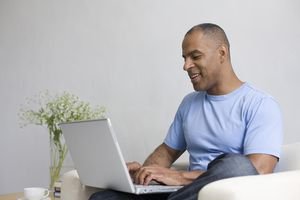 Mature man typing on laptop