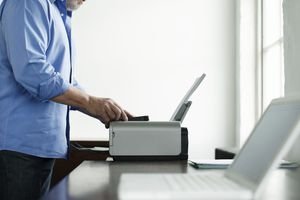 Man Using Computer Printer