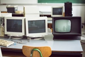 Older CRT monitors on a desk.