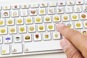 Hand using emoticon keyboard