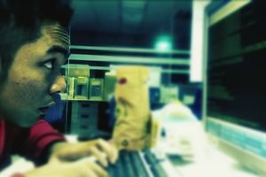 Side-view of a hacker-type male using a computer