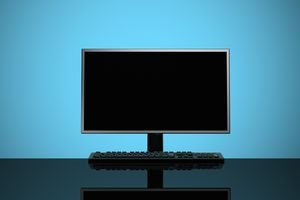Picture of a black monitor in front of a blue background