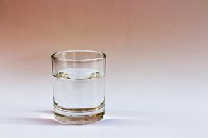 Close-up of water in glass against white background